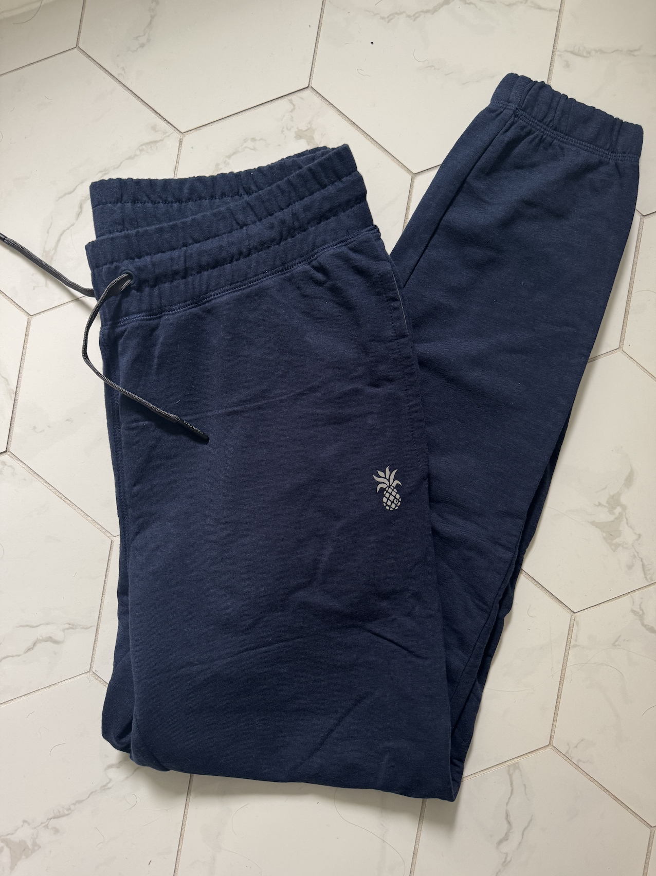 Blue Jogger from Cariloha laid on tile 
